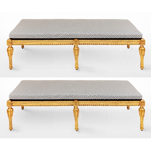 A fine pair of Italian neoclassical carved giltwood banquettes.